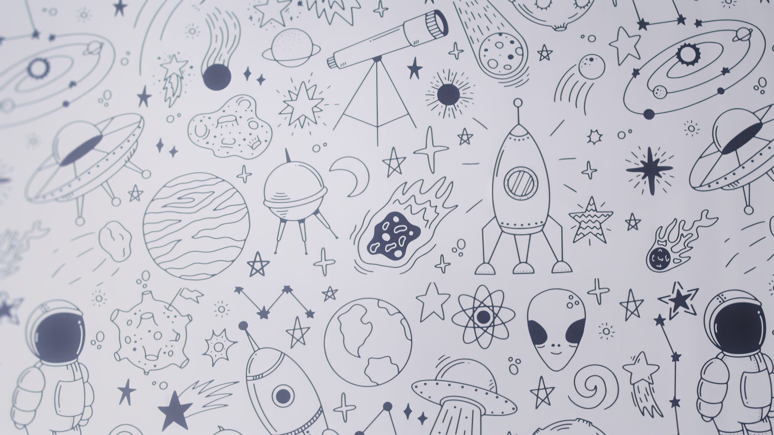 Space-themed doodle wallpaper in the children's play area at SmileCraft Dental