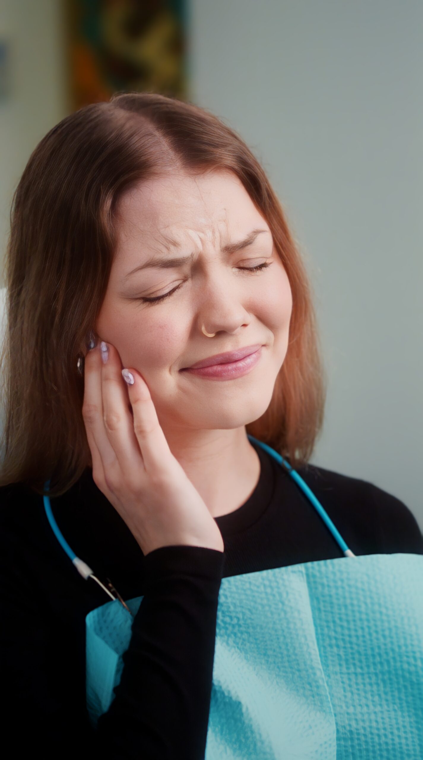 A person holding their jaw, showing where dental pain is felt