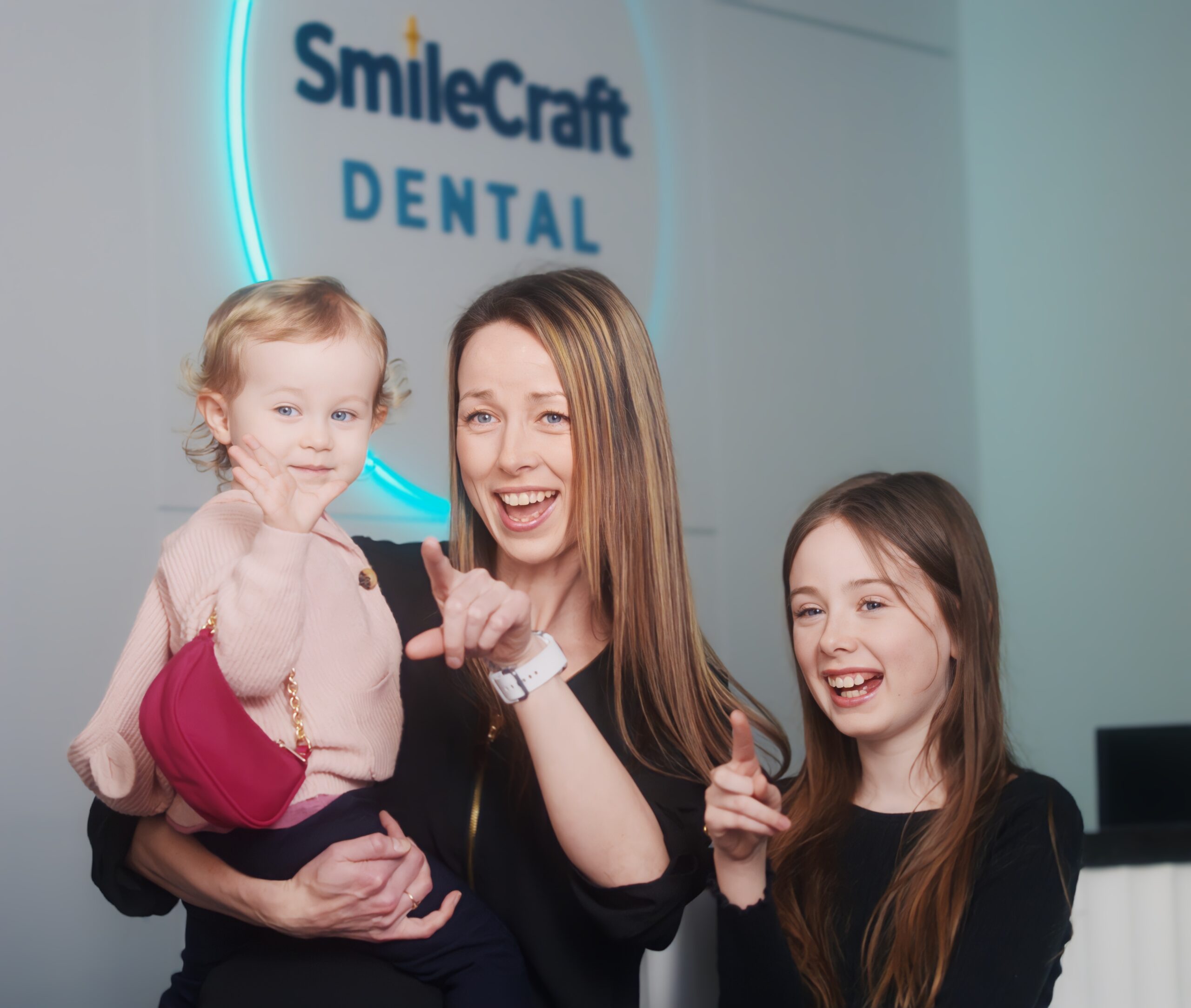 A mother with her two children at SmileCraft Dental reception in Willoughby, Langley