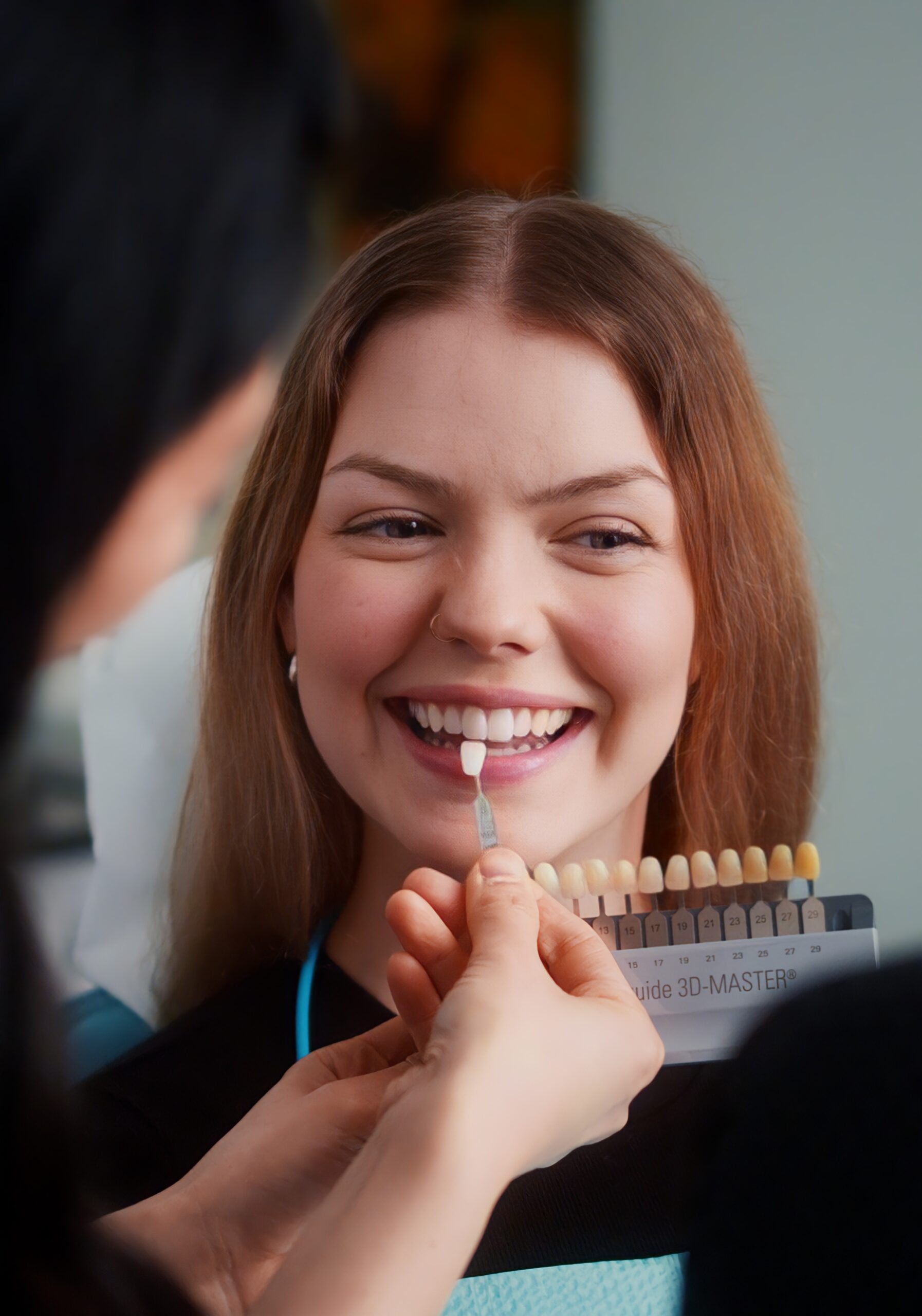 Dental shade guide held up to compare tooth colour at SmileCraft Dental