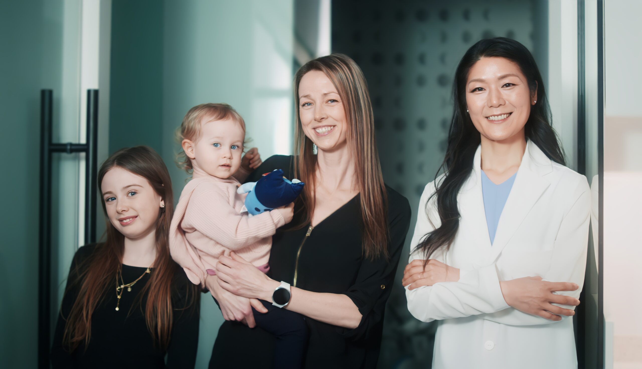 Dr. Jinny Han with a mother and her two children at SmileCraft Dental in Langley